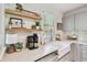 Kitchen featuring open shelving, a farmhouse sink, and quartz countertops at 848 9Th S Ave, St Petersburg, FL 33701