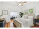 Bright main bedroom with hardwood floors, ceiling fan, stylish decor and bathroom with claw foot tub at 848 9Th S Ave, St Petersburg, FL 33701