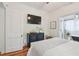 Charming bedroom features a decorative cabinet, TV, and a glimpse into the luxurious ensuite bathroom at 848 9Th S Ave, St Petersburg, FL 33701