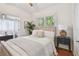 Inviting main bedroom with an upholstered headboard, ensuite bath, and warm, natural light from bright windows at 848 9Th S Ave, St Petersburg, FL 33701