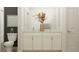 Bright bathroom with a double vanity, granite countertop and decorative vase with floral arrangement at 9414 Gladsome Dr, Land O Lakes, FL 34637