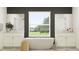 Spa-like bathroom featuring a soaking tub, dual sinks, and a window with a beautiful view of the yard at 9414 Gladsome Dr, Land O Lakes, FL 34637