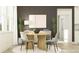 Dining room featuring a round table, modern chairs, and a stylish accent wall at 9414 Gladsome Dr, Land O Lakes, FL 34637