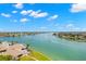 Stunning aerial view of the waterfront property featuring a serene pool and lush green landscaping at 9425 Blind Pass Rd # 1008, St Pete Beach, FL 33706