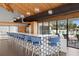 Modern bar area with blue bar stools and sleek countertops, providing a stylish space for community gatherings at 9425 Blind Pass Rd # 1008, St Pete Beach, FL 33706