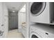 Bathroom featuring modern stacked washer and dryer and glass enclosed shower at 9425 Blind Pass Rd # 1008, St Pete Beach, FL 33706