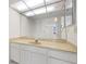 Bright bathroom with white vanity, sink, and large mirror at 9425 Blind Pass Rd # 1008, St Pete Beach, FL 33706