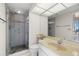 Updated bathroom with a glass shower enclosure, modern fixtures, and ample lighting at 9425 Blind Pass Rd # 1008, St Pete Beach, FL 33706