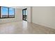 Bedroom with natural light, tiled flooring, and balcony access at 9425 Blind Pass Rd # 1008, St Pete Beach, FL 33706