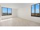 Bright bedroom with neutral walls, tile flooring, and beautiful windows with city views at 9425 Blind Pass Rd # 1008, St Pete Beach, FL 33706