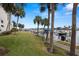 Waterfront property features a convenient dock with boat slips and grassy area with tropical palm trees at 9425 Blind Pass Rd # 1008, St Pete Beach, FL 33706