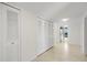 Hallway with storage leading into kitchen with exterior views at 9425 Blind Pass Rd # 1008, St Pete Beach, FL 33706