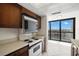 Kitchen with retro oven appliance and expansive waterfront view at 9425 Blind Pass Rd # 1008, St Pete Beach, FL 33706