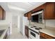 Kitchen with wood cabinets and retro appliances at 9425 Blind Pass Rd # 1008, St Pete Beach, FL 33706