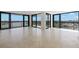 Bright living room featuring tile floors, balcony access, and stunning waterfront views at 9425 Blind Pass Rd # 1008, St Pete Beach, FL 33706