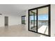 Bright living room featuring tile floors, balcony access and abundant natural light at 9425 Blind Pass Rd # 1008, St Pete Beach, FL 33706