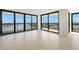Bright living room featuring tile floors, balcony access and abundant natural light at 9425 Blind Pass Rd # 1008, St Pete Beach, FL 33706