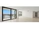 Bright living room featuring tile floors, balcony access and abundant natural light at 9425 Blind Pass Rd # 1008, St Pete Beach, FL 33706