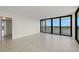 Bright living room featuring tile floors, balcony access and abundant natural light at 9425 Blind Pass Rd # 1008, St Pete Beach, FL 33706