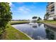 Scenic water view from the property overlooking a tranquil pond with fountain and lush landscaping at 9425 Blind Pass Rd # 1008, St Pete Beach, FL 33706