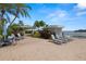 Waterfront pool area with lounge chairs, tables, and a cabana offering a picturesque outdoor space to enjoy at 9425 Blind Pass Rd # 1008, St Pete Beach, FL 33706