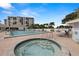 Community pool and hot tub providing residents a perfect outdoor relaxation space with a view at 9425 Blind Pass Rd # 1008, St Pete Beach, FL 33706