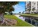 Beautiful waterfront with canal, fountain, palm trees and landscaping at 9425 Blind Pass Rd # 1008, St Pete Beach, FL 33706