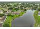 Wide aerial view of a waterfront community, with lush landscaping and nearby golf course at 1012 Radison Lake Ct # 59, Sun City Center, FL 33573
