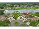 Stunning aerial view of homes surrounding a tranquil lake, lush landscaping, and cul-de-sac at 1012 Radison Lake Ct # 59, Sun City Center, FL 33573