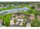 Aerial view of the community homes with mature trees and a serene pond at 1012 Radison Lake Ct # 59, Sun City Center, FL 33573