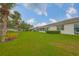 Manicured lawn behind the property, offering a serene and private outdoor space at 1012 Radison Lake Ct # 59, Sun City Center, FL 33573