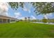 Lush green lawn extending to the lake, providing a tranquil waterfront view at 1012 Radison Lake Ct # 59, Sun City Center, FL 33573