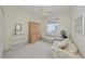 Bedroom features neutral carpeting, sleeper sofa, and window at 1012 Radison Lake Ct # 59, Sun City Center, FL 33573