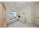 Bedroom featuring neutral carpeting, sleeper sofa, and window at 1012 Radison Lake Ct # 59, Sun City Center, FL 33573
