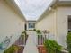 Inviting walkway with white railings leading to the home's entrance with bright blue window at 1012 Radison Lake Ct # 59, Sun City Center, FL 33573