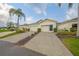 Charming home featuring a two-car garage, well-manicured landscaping, and a welcoming entrance at 1012 Radison Lake Ct # 59, Sun City Center, FL 33573