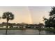 Picturesque view of homes by a pond, with a rainbow in the distance at 1012 Radison Lake Ct # 59, Sun City Center, FL 33573