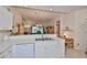 Bright kitchen with white cabinets, modern appliances, and an open view to the living area at 1012 Radison Lake Ct # 59, Sun City Center, FL 33573