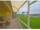 Relaxing lanai overlooking a beautiful pond and well-maintained green lawn at 1012 Radison Lake Ct # 59, Sun City Center, FL 33573