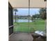 Relaxing lanai with views of a pond with two birds foraging on the lawn at 1012 Radison Lake Ct # 59, Sun City Center, FL 33573