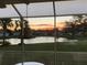 Lanai view of a picturesque sunset reflecting on a serene pond at 1012 Radison Lake Ct # 59, Sun City Center, FL 33573