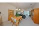 Cozy living area with wood furniture, chandelier and view to screened patio with chairs and table at 1012 Radison Lake Ct # 59, Sun City Center, FL 33573