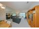Spacious living room with large mirror, entertainment center, leather furniture and patio access at 1012 Radison Lake Ct # 59, Sun City Center, FL 33573