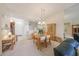Open floor plan with dining and living area featuring neutral tones, light fixtures, and access to kitchen at 1012 Radison Lake Ct # 59, Sun City Center, FL 33573