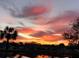 Picturesque sunset view over a tranquil lake, reflecting vibrant sky colors at 1012 Radison Lake Ct # 59, Sun City Center, FL 33573