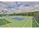 The community boasts well-maintained tennis courts with vibrant green and blue surfaces and lush landscaping at 1012 Radison Lake Ct # 59, Sun City Center, FL 33573