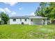 Backyard of the house with a covered patio at 109 Magnolia Ave, Seffner, FL 33584