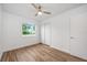 Bedroom featuring modern ceiling fan, hardwood floors, and closet at 109 Magnolia Ave, Seffner, FL 33584