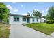 Charming single story home with well manicured front lawn and long concrete driveway at 109 Magnolia Ave, Seffner, FL 33584