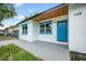 Charming home featuring a blue front door and wood plank awning at 109 Magnolia Ave, Seffner, FL 33584
